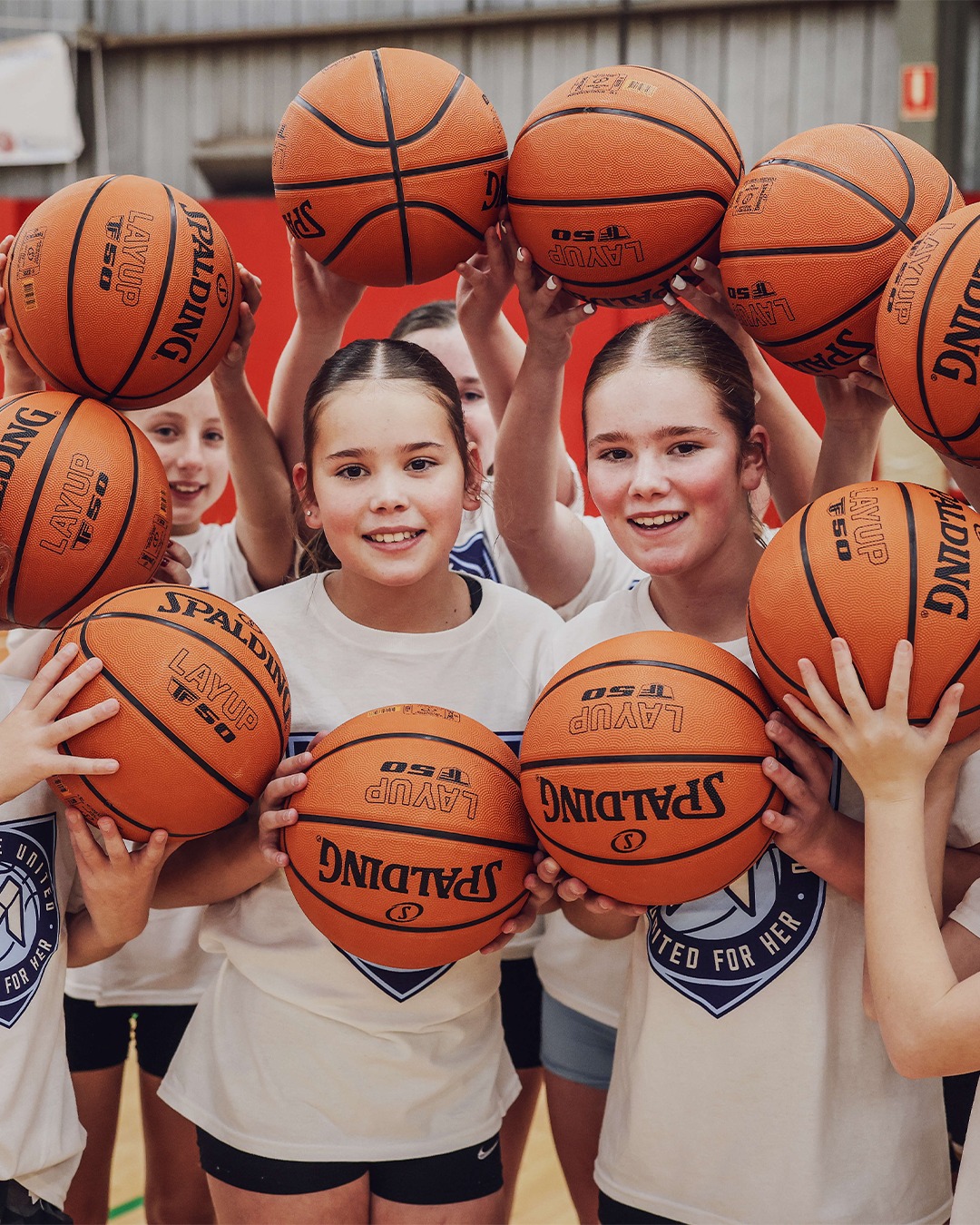 Teenage girls working on skills at a United for Her basketball clinic