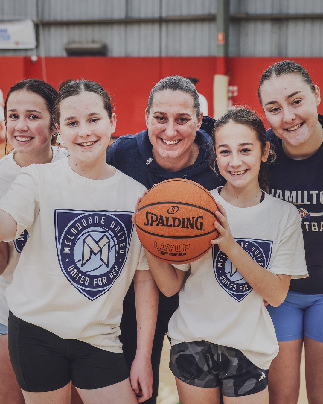 Young girls taking part in a United for Her basketball clinic